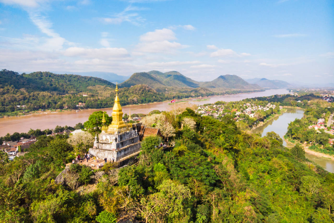 1280 golden pagoda of Wat Chom Si on the top of Mount Phou Si shutterstock 1402519127
