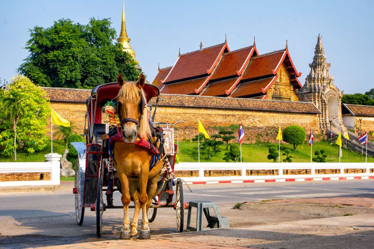 800 Horse carriage stand in front of Wat Phra That Lampang Luang shutterstock 1100505608
