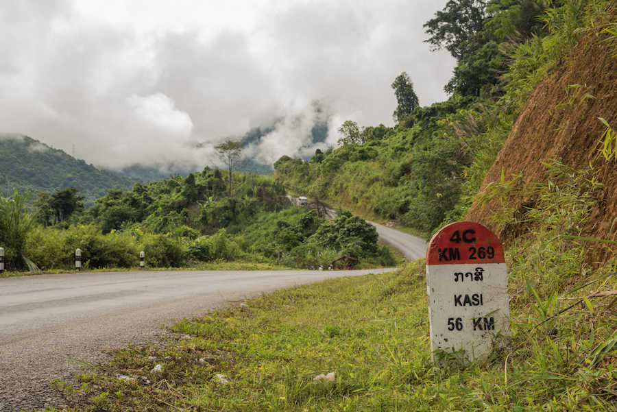 Web 900 Kasi milestone with road mountain AdobeStock 208645439