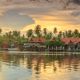 1280 Reflections of Thai houses near Mae Klong River at sunset Amphawa Samut Songkhram AdobeStock 470234303